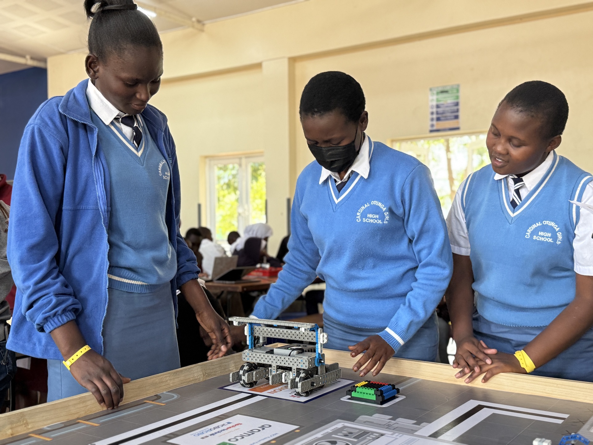 Girls examining VEX robot